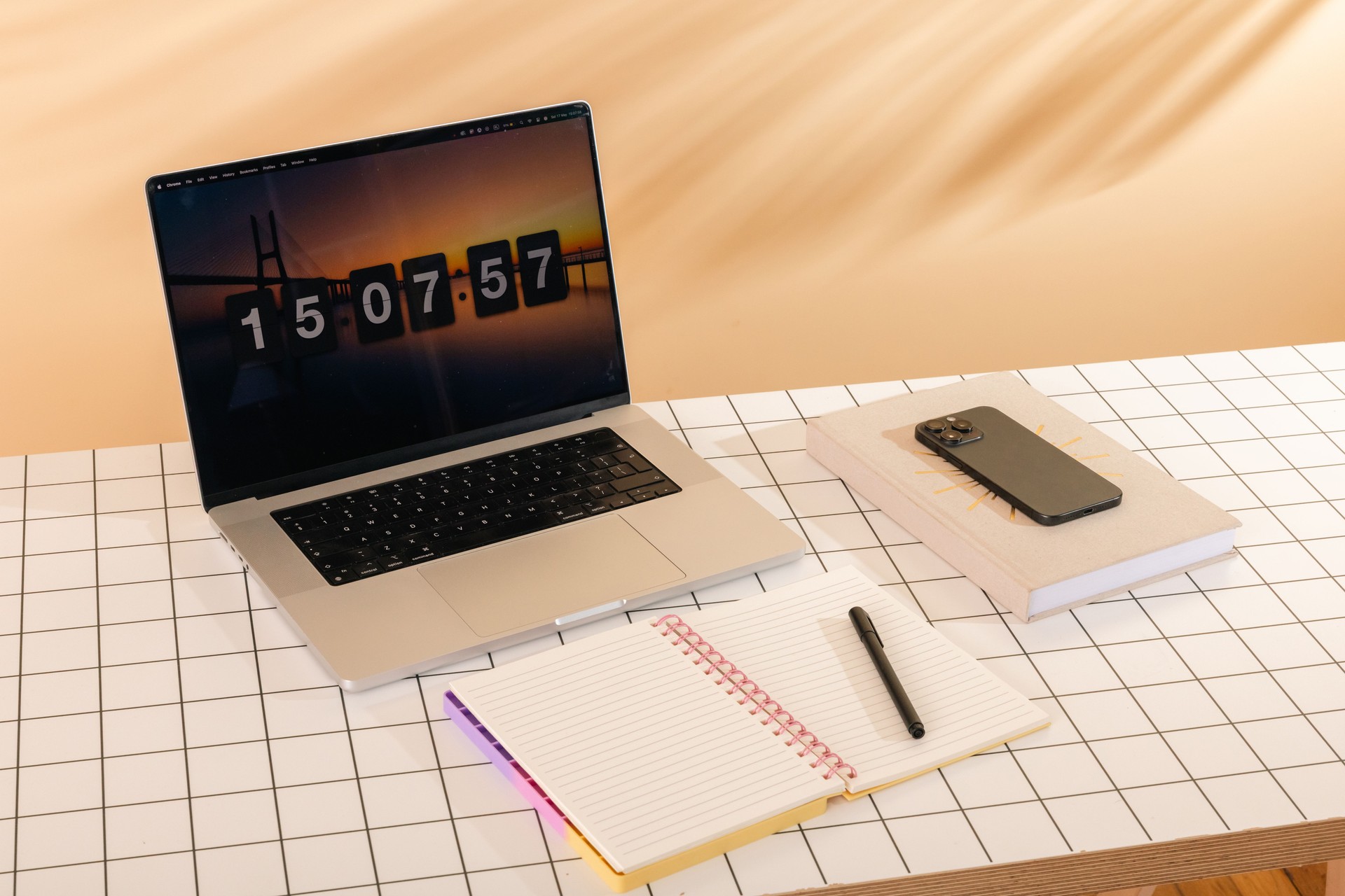 Productive Workstation: Laptop with Timer, Notebook, Smartphone, and Planner on Grid Desk